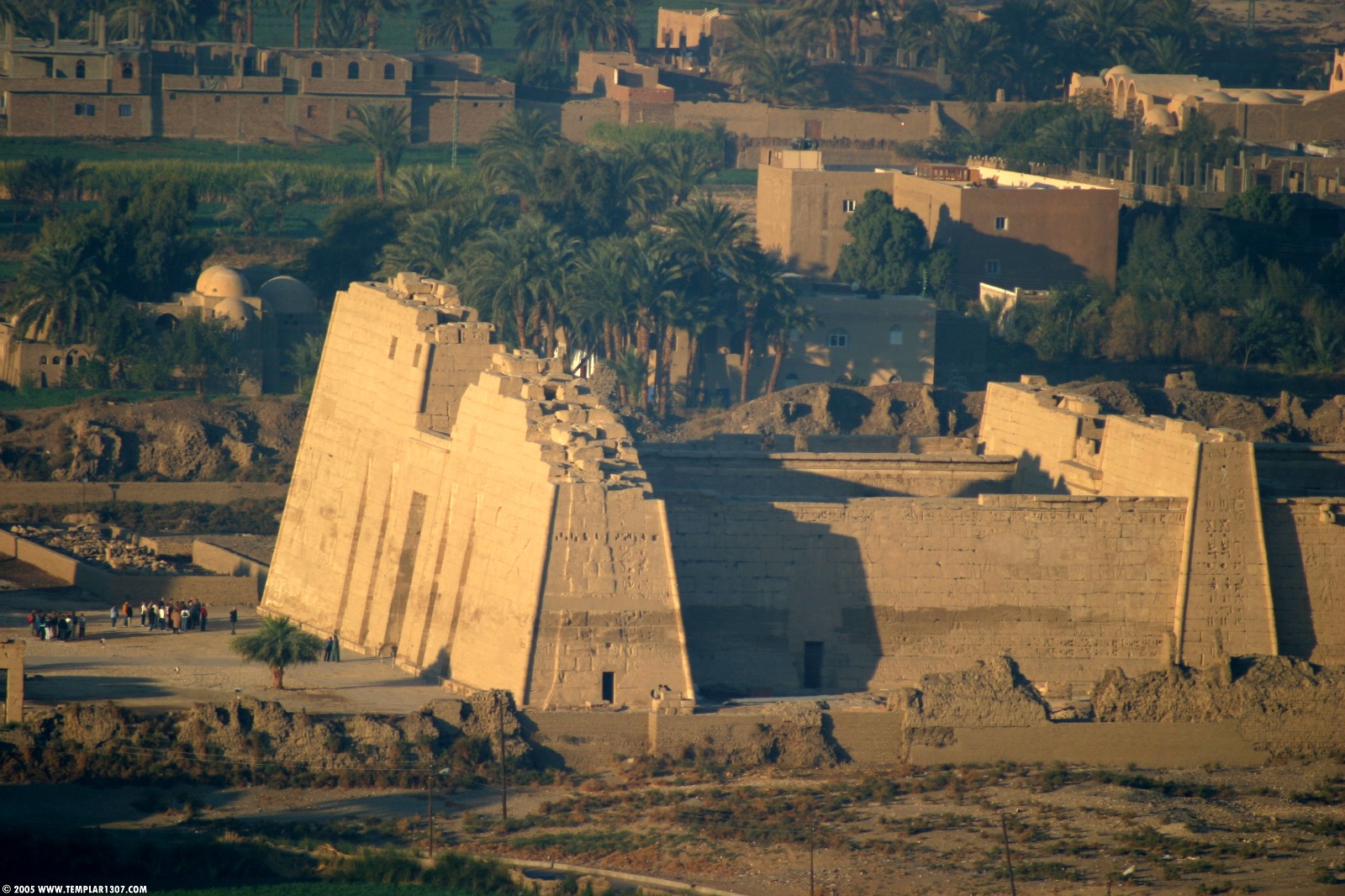 The Mortuary Temple of Ramesses III at Medinet Habu, with colossal statues and well-preserved reliefs on the West Bank of Luxor, Egypt.